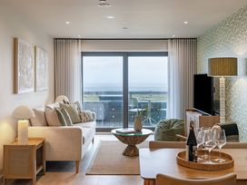 A living room with a sofa and a view of the sea at tbc in St. Ives