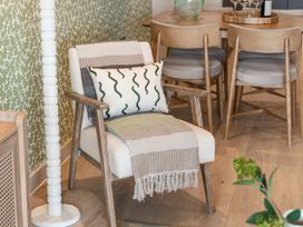 A chair with a pillow and blanket in a dining area at tbc in St. Ives