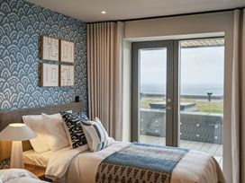 A bedroom with a bed and wall art at tbc in St. Ives