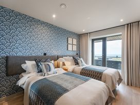 A bedroom with two beds and a window at tbc St. Ives