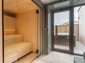 A spa room featuring a sauna and hot tub at Hidden 13- Skyline Terrace St Ives