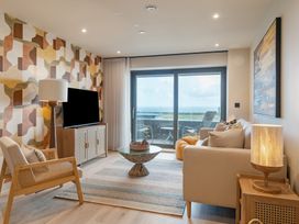 A living room with a television and sofa at tbc in St. Ives