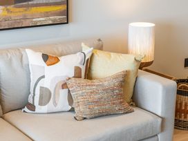 A living room with a sofa and decorative pillows at tbc in St. Ives