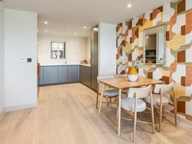 A kitchen area with a dining table and chairs at tbc in St. Ives