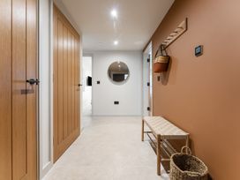 A hallway with wooden doors and a bench at tbc in St. Ives