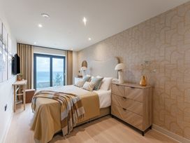 A bedroom with a bed and television at tbc in St. Ives