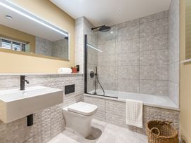 A bathroom with a sink, toilet, and bathtub at tbc in St. Ives