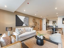 A living room with a sofa and dining table at tbc in St. Ives