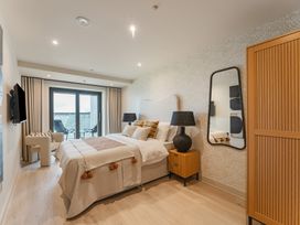 A bedroom with a bed and nightstand at tbc in St. Ives