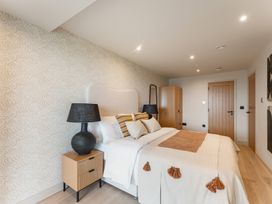 A bedroom with a bed and a nightstand at tbc in St. Ives