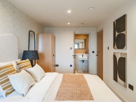 A bedroom with a bed and wardrobe at tbc in St. Ives