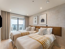 A bedroom with two beds and a sliding door at tbc in St. Ives