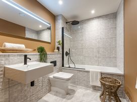 A bathroom with a sink, toilet, and bathtub at tbc in St. Ives