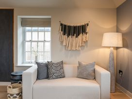 A living room with a sofa and decorative items at tbc in St. Ives