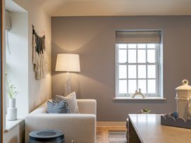 A living room with a sofa and a lamp at tbc in St. Ives