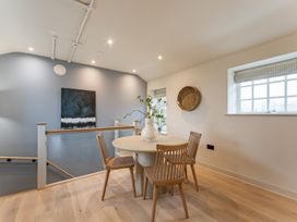 A dining room with a round table and chairs at tbc in St. Ives