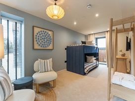 A bedroom with a bunk bed and seating area at tbc in St. Ives