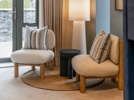 A living room with two chairs and a side table at tbc in St. Ives
