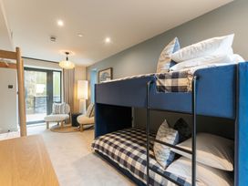 A bedroom with a bunk bed and a seating area at tbc in St. Ives