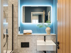 A bathroom with a washbasin and a shower at tbc in St. Ives