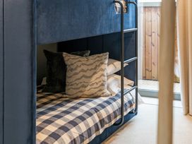 A bunk bed with pillows and sheets at tbc in St. Ives