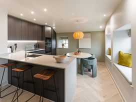 A kitchen with a central island and dining area at tbc in St. Ives