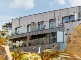 A building with balconies and glass railings at Hidden 7- Coastal Loft St Ives