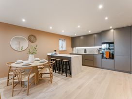 A kitchen with a dining area and modern features at tbc St. Ives