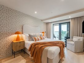 A bedroom with a bed and sliding door at tbc in St. Ives