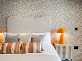 A bedroom with a bed and decorative pillows at tbc in St. Ives