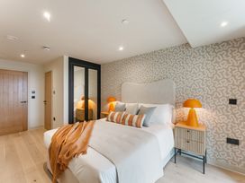 A bedroom with a bed and bedside table at tbc in St. Ives