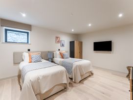 A bedroom with two beds and a television at tbc in St. Ives