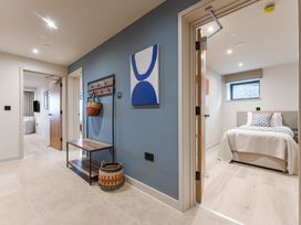 A hallway with a coat rack and connected rooms at tbc in St. Ives