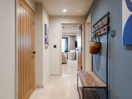 A hallway with a coat rack and bench at tbc in St. Ives