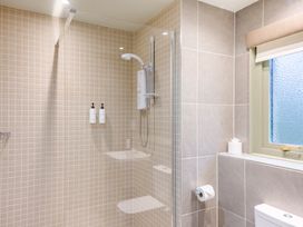 A bathroom with a shower and toiletries at The Derwent Spa (Pet) in Slaley