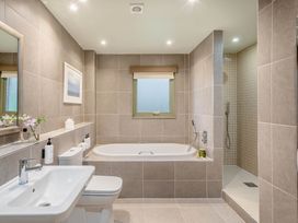 A bathroom with a bathtub, sink and shower at The Derwent Spa (Pet) Slaley