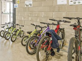 A bike storage area with various bicycles and signs at Sidlaw Spa in Fowlis near Dundee