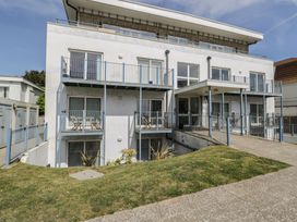 A building with balconies and a lawn at 7 Blue Water Bournemouth