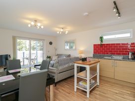 A living room with a sofa and dining table at 7 Blue Water Bournemouth