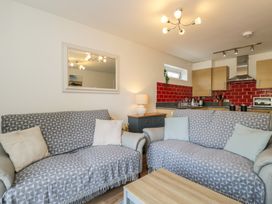A living room with sofas and a coffee table at 7 Blue Water in Bournemouth