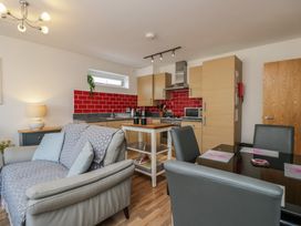 A kitchen with a dining table and chairs at 7 Blue Water in Bournemouth