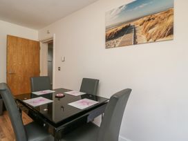 A dining room with a table and chairs at 7 Blue Water Bournemouth
