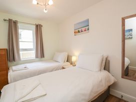 A bedroom with two single beds and a window at 7 Blue Water in Bournemouth