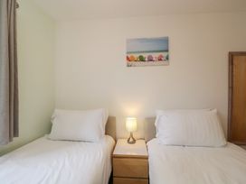 A bedroom with two beds and a lamp at 7 Blue Water in Bournemouth