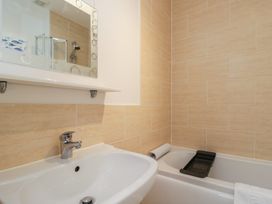 A bathroom with a sink and a bathtub at 7 Blue Water in Bournemouth