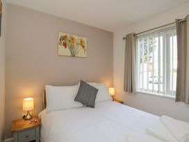 A bedroom with a bed and nightstand at 7 Blue Water Bournemouth