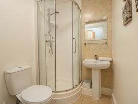 A bathroom with a shower, sink, and toilet at 7 Blue Water Bournemouth