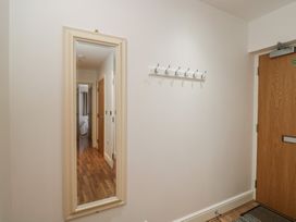 A hallway with a mirror and coat hooks at 7 Blue Water in Bournemouth