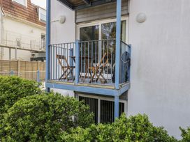 A balcony with chairs and a table at 7 Blue Water in Bournemouth