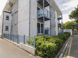 An outdoor view of a building with balconies and bushes at 7 Blue Water in Bournemouth